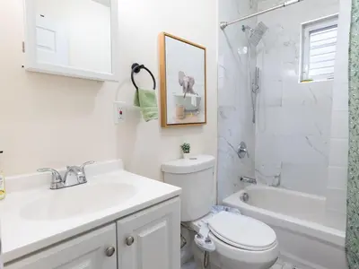 a bathroom with a toilet and a sink and a shower at New 4 Apts-198-3 Bed Apt 1st Floor & 3 Bed Apt 2nd Floor - 1 Bed Studio Apt Ground Floor & 1 Bed Studio Apt Ground Floor near Penn Station EWR Newark NJ Airport Hospital Manhattan NYC in Newark