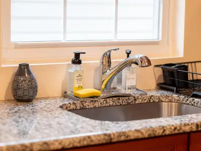 a kitchen counter with a sink and a window at New 4 Apts-198-3 Bed Apt 1st Floor & 3 Bed Apt 2nd Floor - 1 Bed Studio Apt Ground Floor & 1 Bed Studio Apt Ground Floor near Penn Station EWR Newark NJ Airport Hospital Manhattan NYC in Newark