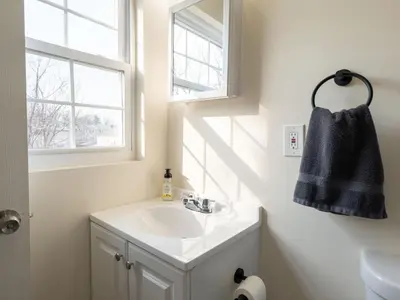 a bathroom with a sink and a window at New 4 Apts-198-3 Bed Apt 1st Floor & 3 Bed Apt 2nd Floor - 1 Bed Studio Apt Ground Floor & 1 Bed Studio Apt Ground Floor near Penn Station EWR Newark NJ Airport Hospital Manhattan NYC in Newark