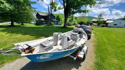 a blue and white boat parked in a yard at Historical Home with Amenities Nearby - Delaware River, General Store, Post Office, Tavern in Equinunk