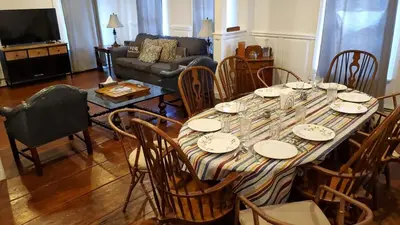 a dining room with a table with chairs and a couch at Historical Home with Amenities Nearby - Delaware River, General Store, Post Office, Tavern in Equinunk