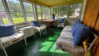 a room with two beds and a table and windows at Historical Home with Amenities Nearby - Delaware River, General Store, Post Office, Tavern in Equinunk