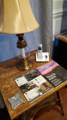 a table with a lamp and a book and a phone at Historical Home with Amenities Nearby - Delaware River, General Store, Post Office, Tavern in Equinunk