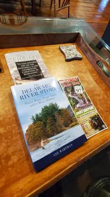a book sitting on top of a wooden table at Historical Home with Amenities Nearby - Delaware River, General Store, Post Office, Tavern in Equinunk