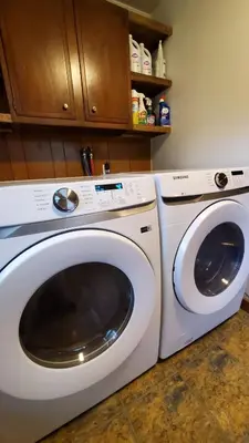 a white washing machine sitting next to a washer at LARGE Open Floor Plan for Your Entertainment with a Short Walk to West Branch Delaware for Water fun and Fishing in Hancock