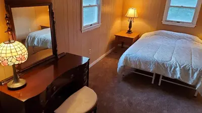 a bedroom with a bed and a desk with a mirror at LARGE Open Floor Plan for Your Entertainment with a Short Walk to West Branch Delaware for Water fun and Fishing in Hancock