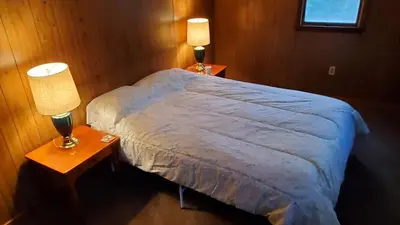 a bedroom with a large bed with two night stands at LARGE Open Floor Plan for Your Entertainment with a Short Walk to West Branch Delaware for Water fun and Fishing in Hancock
