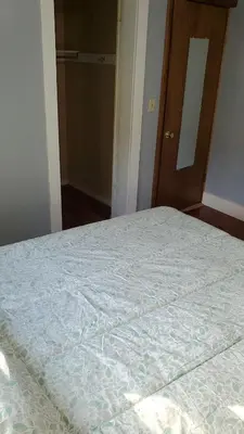 an empty bed in a room with a door at LARGE Open Floor Plan for Your Entertainment with a Short Walk to West Branch Delaware for Water fun and Fishing in Hancock