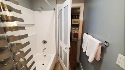 a white bathroom with a shower and a sink at LARGE Open Floor Plan for Your Entertainment with a Short Walk to West Branch Delaware for Water fun and Fishing in Hancock