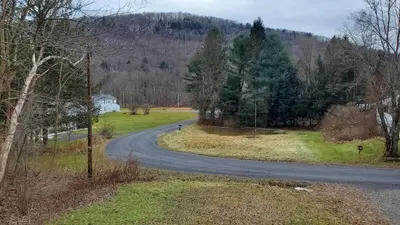 a winding road in the middle of a field at LARGE Open Floor Plan for Your Entertainment with a Short Walk to West Branch Delaware for Water fun and Fishing in Hancock