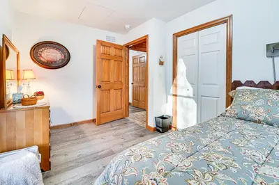 a bedroom with a bed and a wooden floor at Hike, Fish and Unwind Home with Fire Pit in Woodward! in Woodward