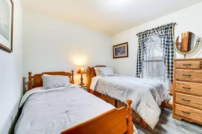 a bedroom with two beds and a dresser and a window at Hike, Fish and Unwind Home with Fire Pit in Woodward! in Woodward