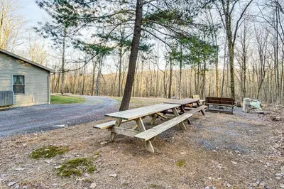 a group of picnic tables sitting next to a tree at Hike, Fish and Unwind Home with Fire Pit in Woodward! in Woodward