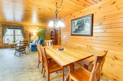 a dining room with a wooden table and chairs at Hike, Fish and Unwind Home with Fire Pit in Woodward! in Woodward