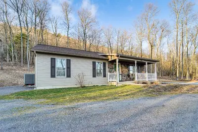 a small house on the side of a road at Hike, Fish and Unwind Home with Fire Pit in Woodward! in Woodward