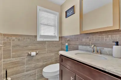 a bathroom with a sink and a toilet at The Seabreeze Haven- Luxury 3BR Coastal Retreat - Near Beach & Free Parking in Keansburg