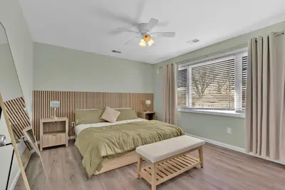 a bedroom with a bed and a ceiling fan at The Seabreeze Haven- Luxury 3BR Coastal Retreat - Near Beach & Free Parking in Keansburg