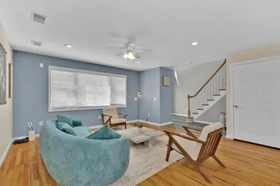 a living room with blue walls and a blue couch at The Seabreeze Haven- Luxury 3BR Coastal Retreat - Near Beach & Free Parking in Keansburg