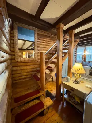 a room with a staircase in a log cabin at Lakefront Cabin with Hot Tub, Views & Fireplace in Lake Harmony