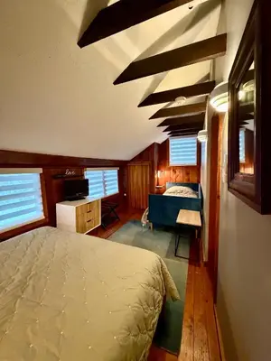 a bedroom with a bed in a room with windows at Lakefront Cabin with Hot Tub, Views & Fireplace in Lake Harmony
