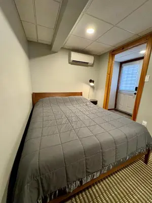 a bedroom with a bed in a room with a window at Lake View Cottage - Private Dock and Fire Pit in Lake Harmony