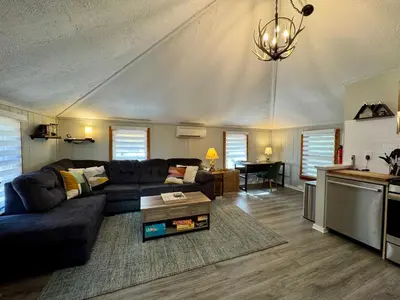 a living room with a couch and a table at Lake View Cottage - Private Dock and Fire Pit in Lake Harmony