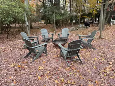 a group of chairs and a table in a park at Lake View Cottage - Private Dock and Fire Pit in Lake Harmony