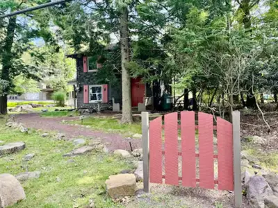 a red sign in front of a house at Lake View Cottage - Private Dock and Fire Pit in Lake Harmony
