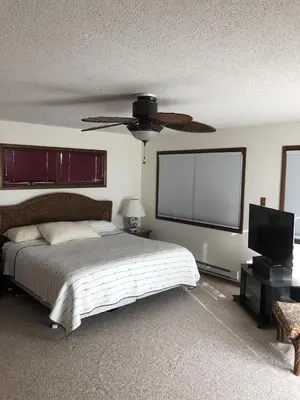 a bedroom with a bed and a flat screen tv at Great Value - Oceanside Raised Ranch Location Is Perfect For Walking To Beach, Restaurants, Pizza, Ice Cream Or Coffee 13419 in Upper Greenwood Lake