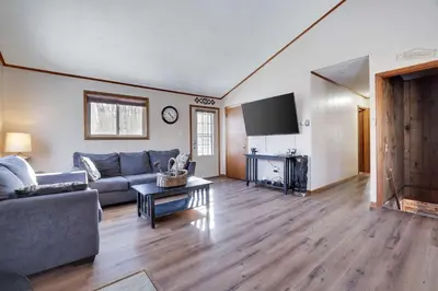 a living room with a couch and a tv at 4 Br Cozy Cabin Sleeps 8 Pool Table Arcade Beach in Gouldsboro