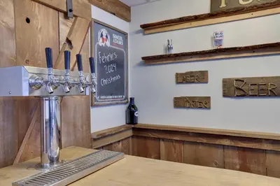 a bar with akeep sign on the wall at 4 Br Cozy Cabin Sleeps 8 Pool Table Arcade Beach in Gouldsboro