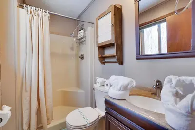 a bathroom with a toilet and a sink and a shower at 4 Br Cozy Cabin Sleeps 8 Pool Table Arcade Beach in Gouldsboro