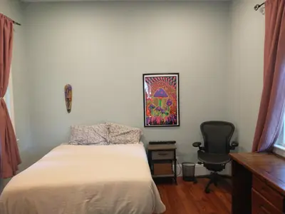 a bedroom with a bed and a desk and a chair at Comfortable 2 Bedroom House with Big Yard 30 Minutes to New York City in Ridgefield Park
