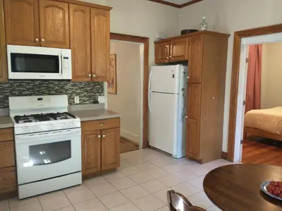 a kitchen with a white stove and a refrigerator at Comfortable 2 Bedroom House with Big Yard 30 Minutes to New York City in Ridgefield Park