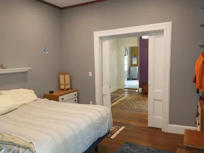 a bedroom with a bed and a door leading to a hallway at Comfortable 2 Bedroom House with Big Yard 30 Minutes to New York City in Ridgefield Park