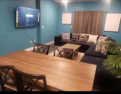 a living room with a table and a couch at Comfy 3 bedroom house in Newark