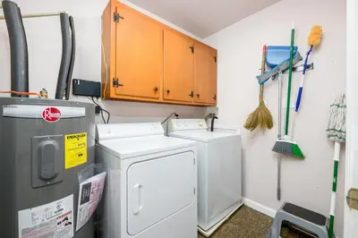a laundry room with a refrigerator and a washer and dryer at Comfortable & Healthy Home in Parkesburg