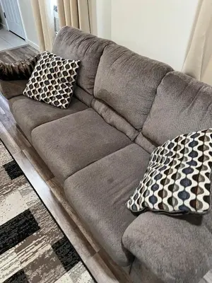 a gray couch with two pillows on it at Spacious and tranquil 5br house in charming East Stroudsburg w game room, pets allowed in East Stroudsburg