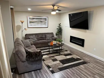 a living room with a couch and a flat screen tv at Spacious and tranquil 5br house in charming East Stroudsburg w game room, pets allowed in East Stroudsburg