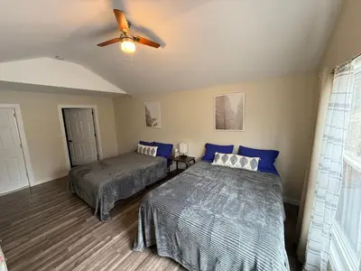 a bedroom with two beds and a ceiling fan at Spacious and tranquil 5br house in charming East Stroudsburg w game room, pets allowed in East Stroudsburg