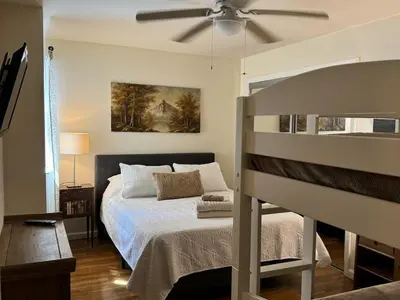 a bedroom with a bed and a ceiling fan at NY - NJ Tennis Suites - Sleeps 40 - 15 Mins to NYC in Union City