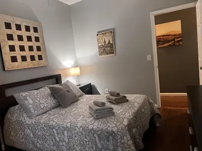 a bedroom with a bed with two towels on it at NY - NJ Tennis Suites - Sleeps 40 - 15 Mins to NYC in Union City