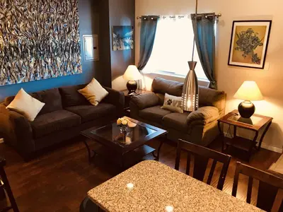 a living room with a couch and a table at NY - NJ Tennis Suites - Sleeps 40 - 15 Mins to NYC in Union City