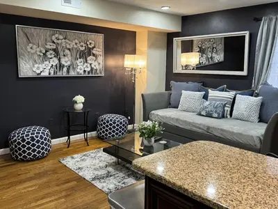 a living room with a couch and a table at NY - NJ Tennis Suites - Sleeps 40 - 15 Mins to NYC in Union City