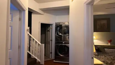 a washer and dryer in a room with a staircase at Max NY VIEW 5 Apartment Combo Sleeps 60 15 Mins to NYC in Union City