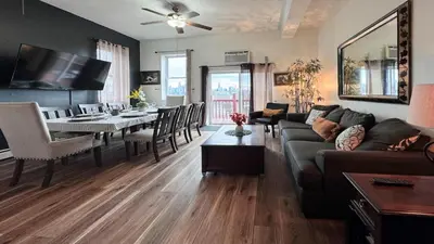 a living room with a couch and a dining room at Max NY VIEW 5 Apartment Combo Sleeps 60 15 Mins to NYC in Union City