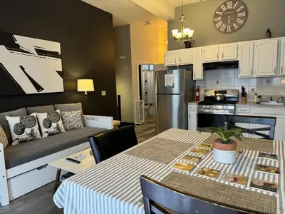 a kitchen and living room with a table and a couch at Max NY VIEW 5 Apartment Combo Sleeps 60 15 Mins to NYC in Union City