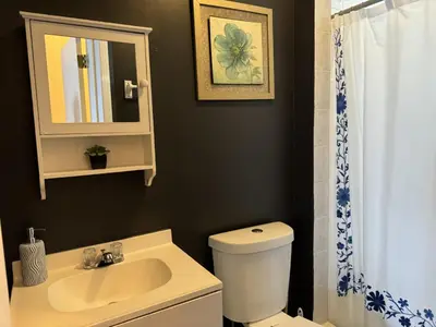 a bathroom with a sink and a toilet and a mirror at Max NY VIEW 5 Apartment Combo Sleeps 60 15 Mins to NYC in Union City