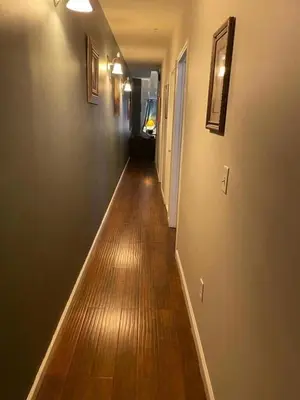 a long hallway with a wooden floor in a house at Ultra Spacious Penthouse - Apt 2 - 3 Combo -15 Mins from NYC in Union City