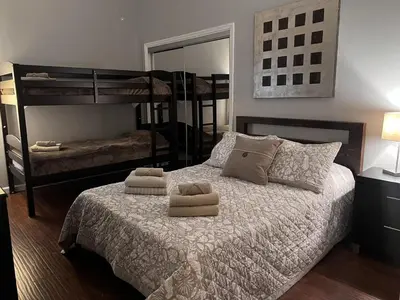 a bedroom with a bed with two bunk beds at Ultra Spacious Penthouse - Apt 2 - 3 Combo -15 Mins from NYC in Union City